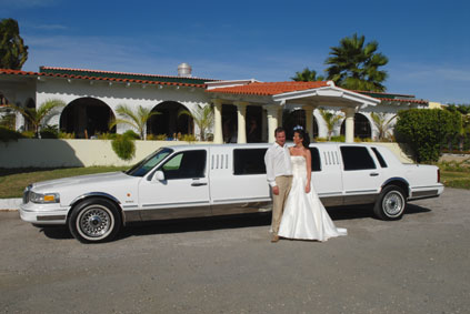 Wedding couple in front of limousine on Aruba